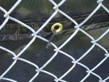 Windscreen attached to the chain link fence with center lacing lip