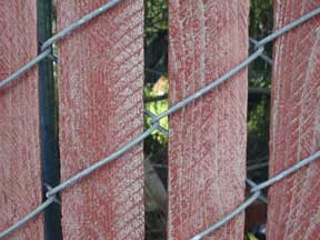 The old industrial wood fence slat. Real wood with a redwood stain. This was popular many years ago. Customers use the plastic Industrial slat to replace the old wooden slats.