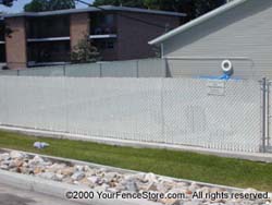 Feather Lock Chain Link Slats surrounds swimming pool.