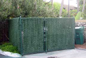 Hedge Link Fence Slats shown around a garbage dumpster.